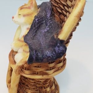 Sleeping Cat Under Blanket In Wicker Chair